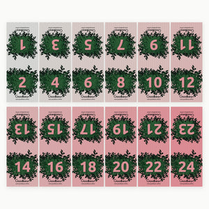 Die zwölf Banderolen des Goodbean Adventskalenders 2026, Farbverlauf von Grau zu Rosa, jede mit zwei Dezembertagen